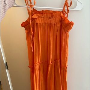 Orange knee length dress. Tie straps